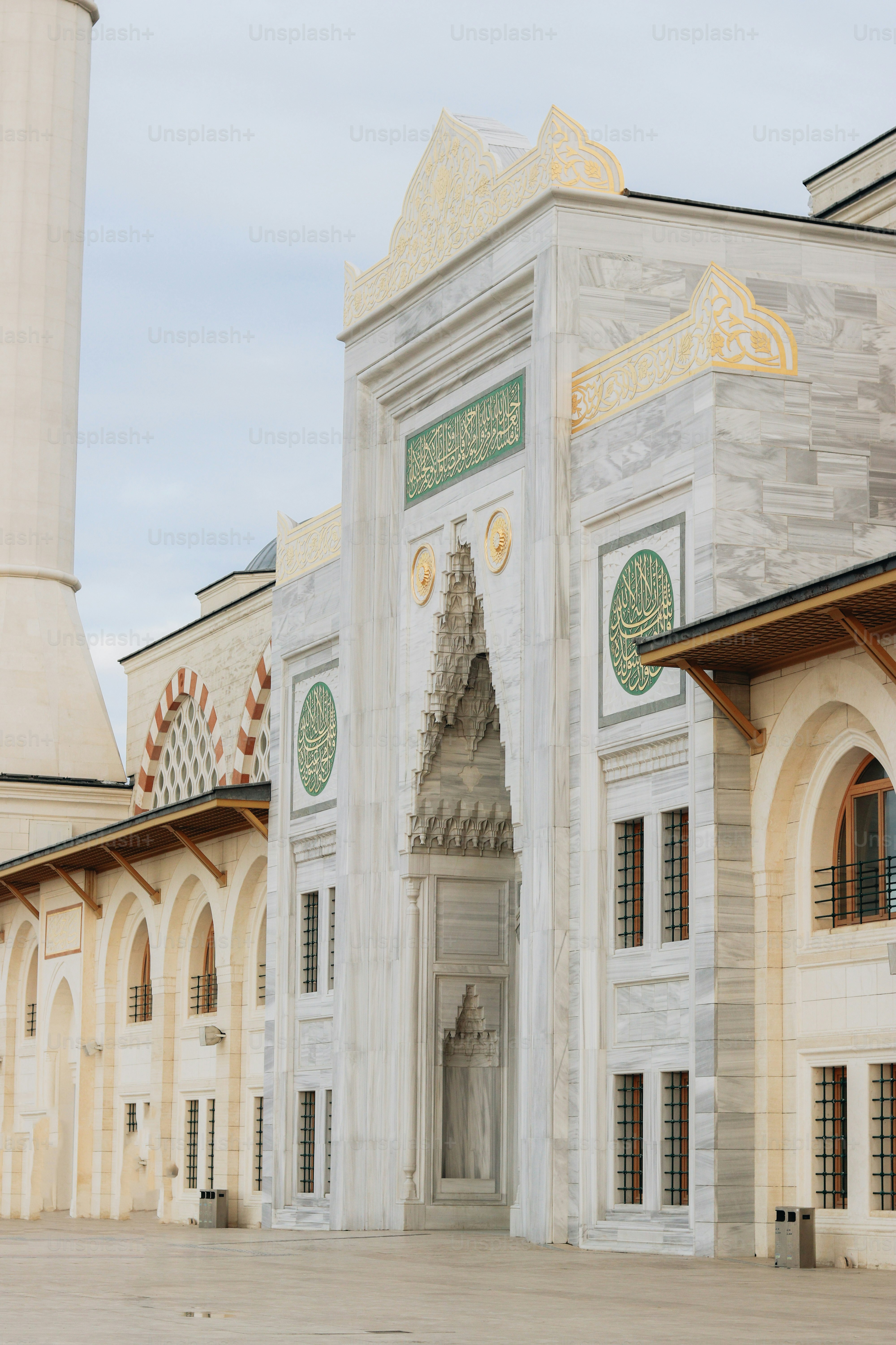 a large white building with a clock tower in the background