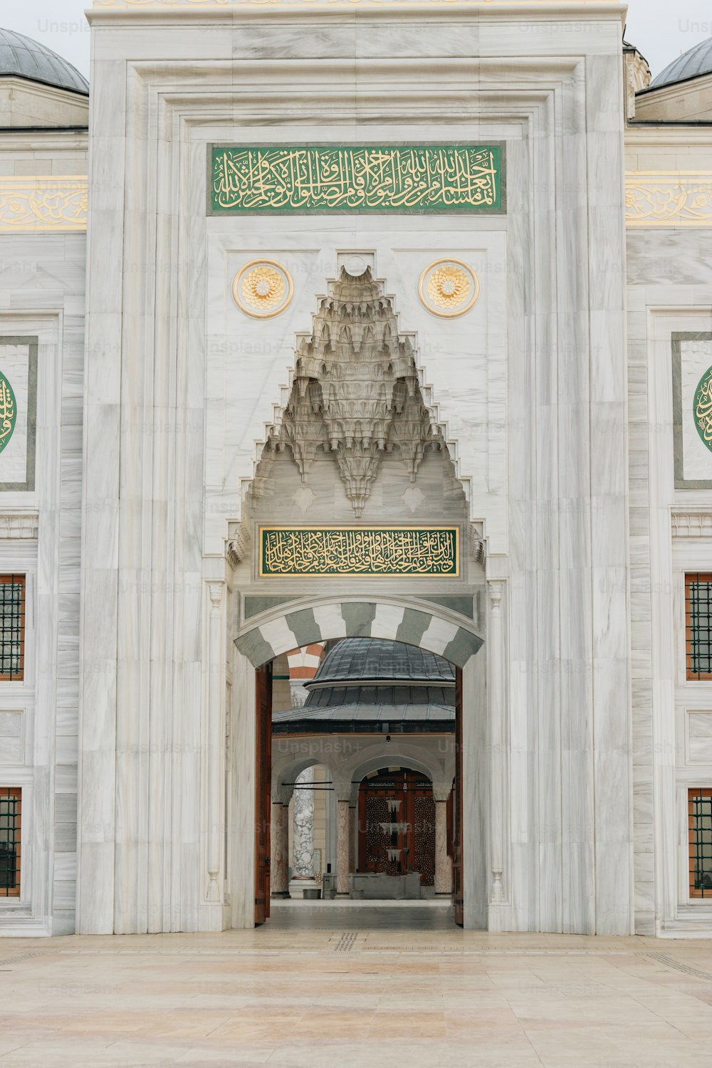 a large white building with a clock on the front of it