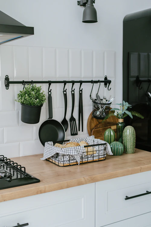 A kitchen counter with pots and pans on it