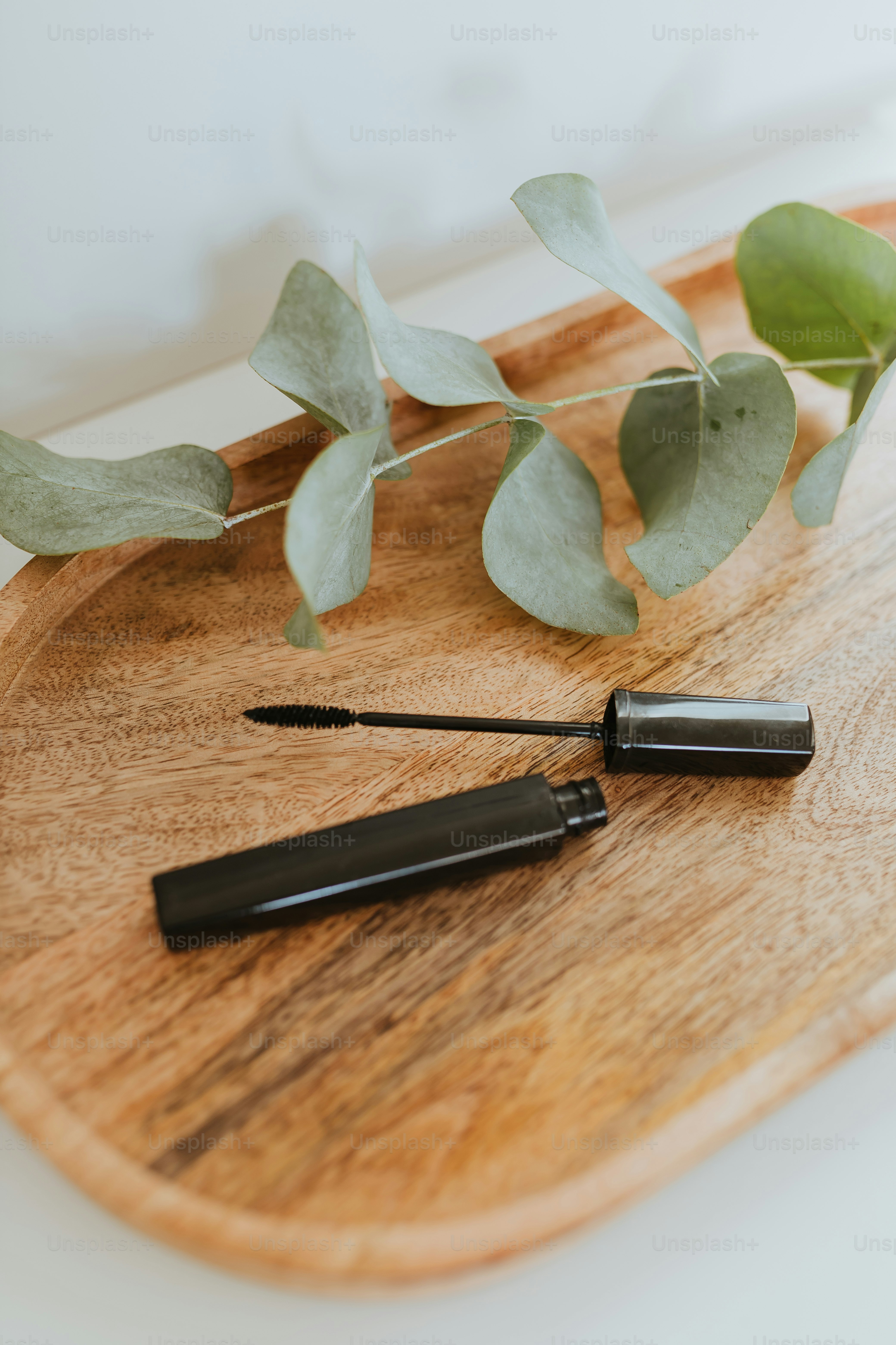 a wooden cutting board topped with a knife and a plant