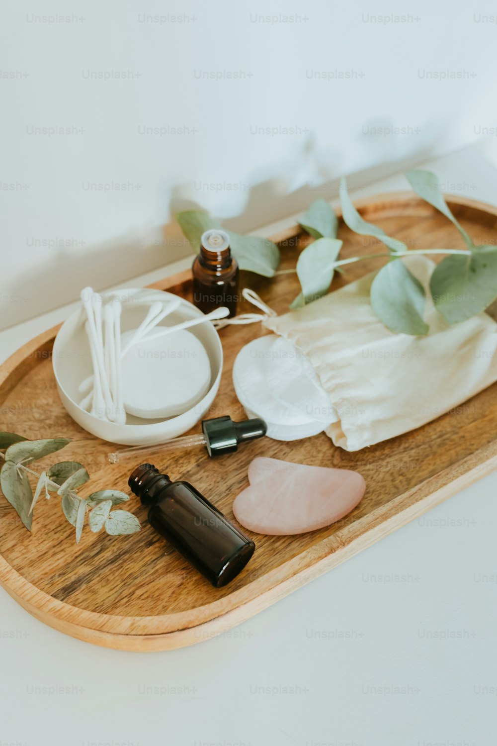 a wooden tray topped with bottles of essentials