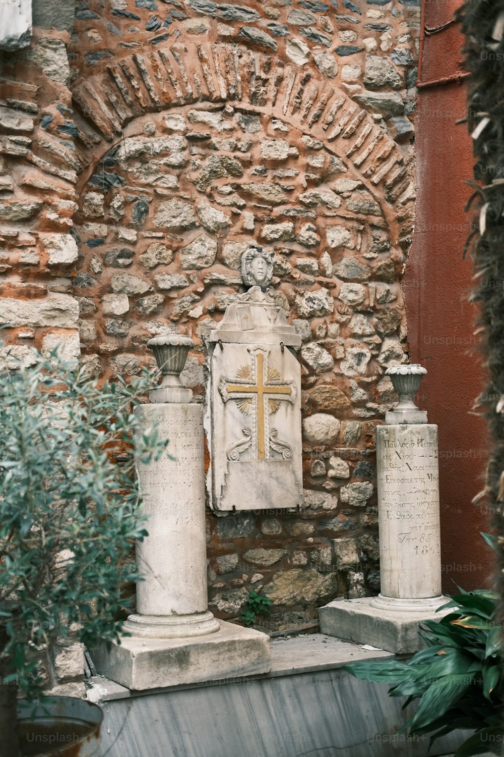a stone wall with a cross on it