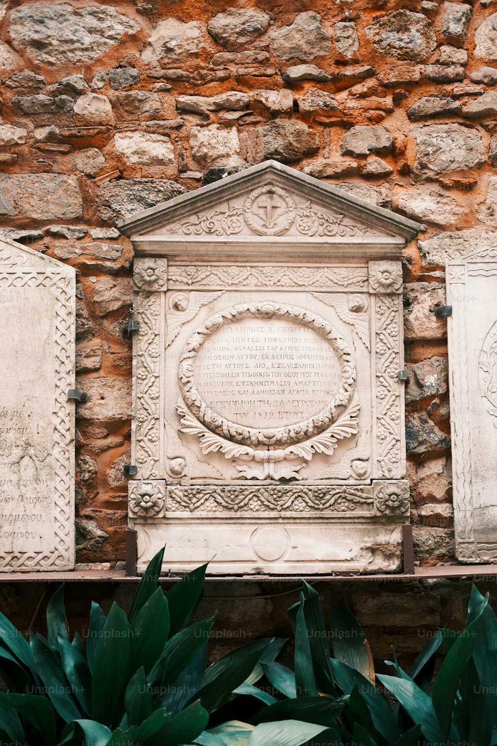 a stone wall with a plaque on top of it