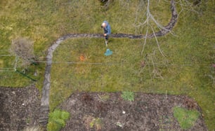 a man walking across a lush green field