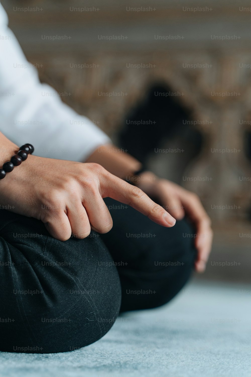 a person sitting on the floor with their hand on the ground