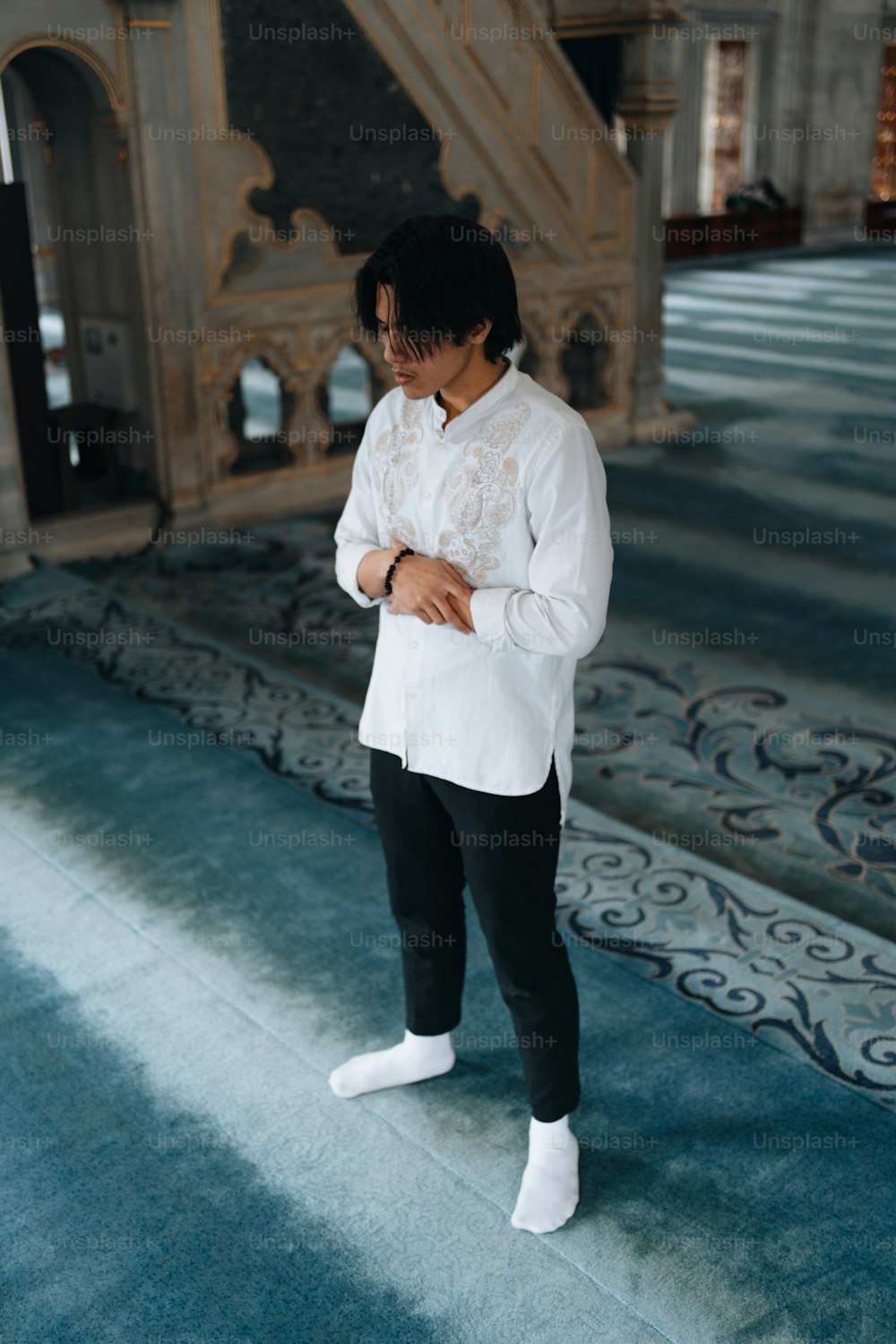 a man in a white shirt and black pants
