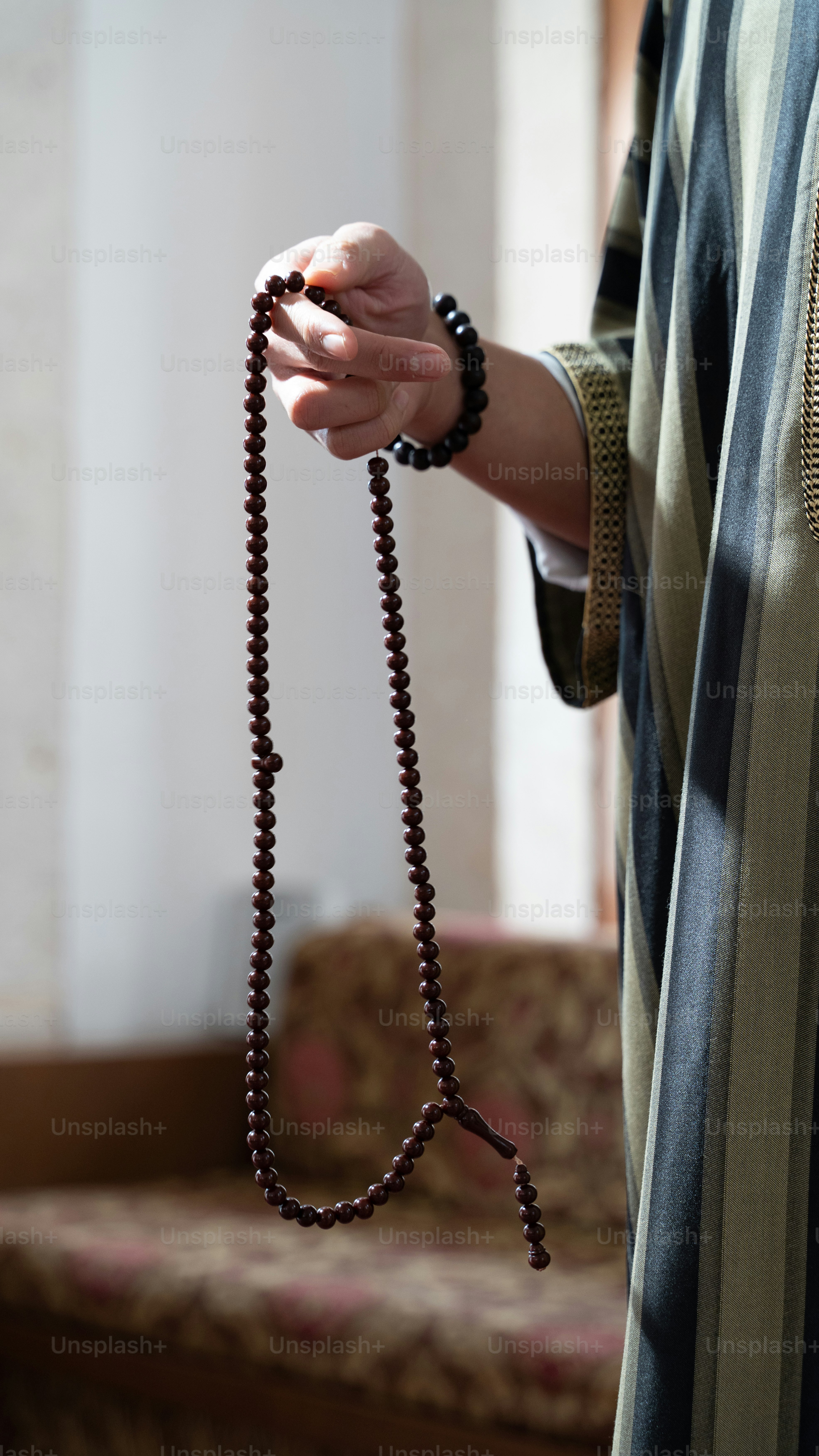 a woman holding a rosary in her hand