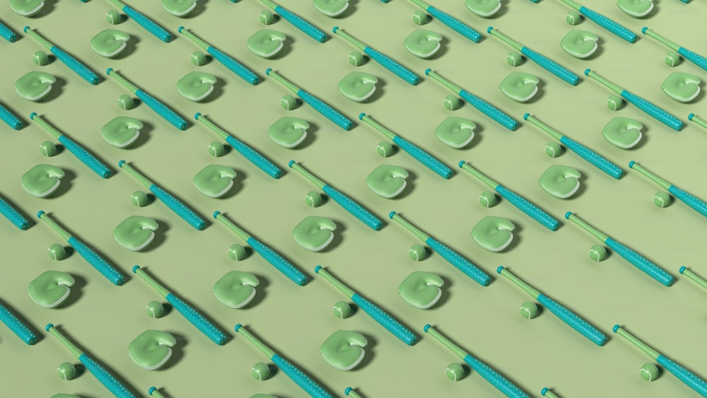 Un grupo de cepillos de dientes azules y verdes sobre una superficie verde