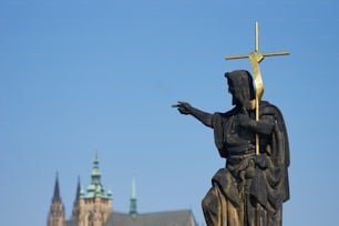 a statue of a person holding a cross