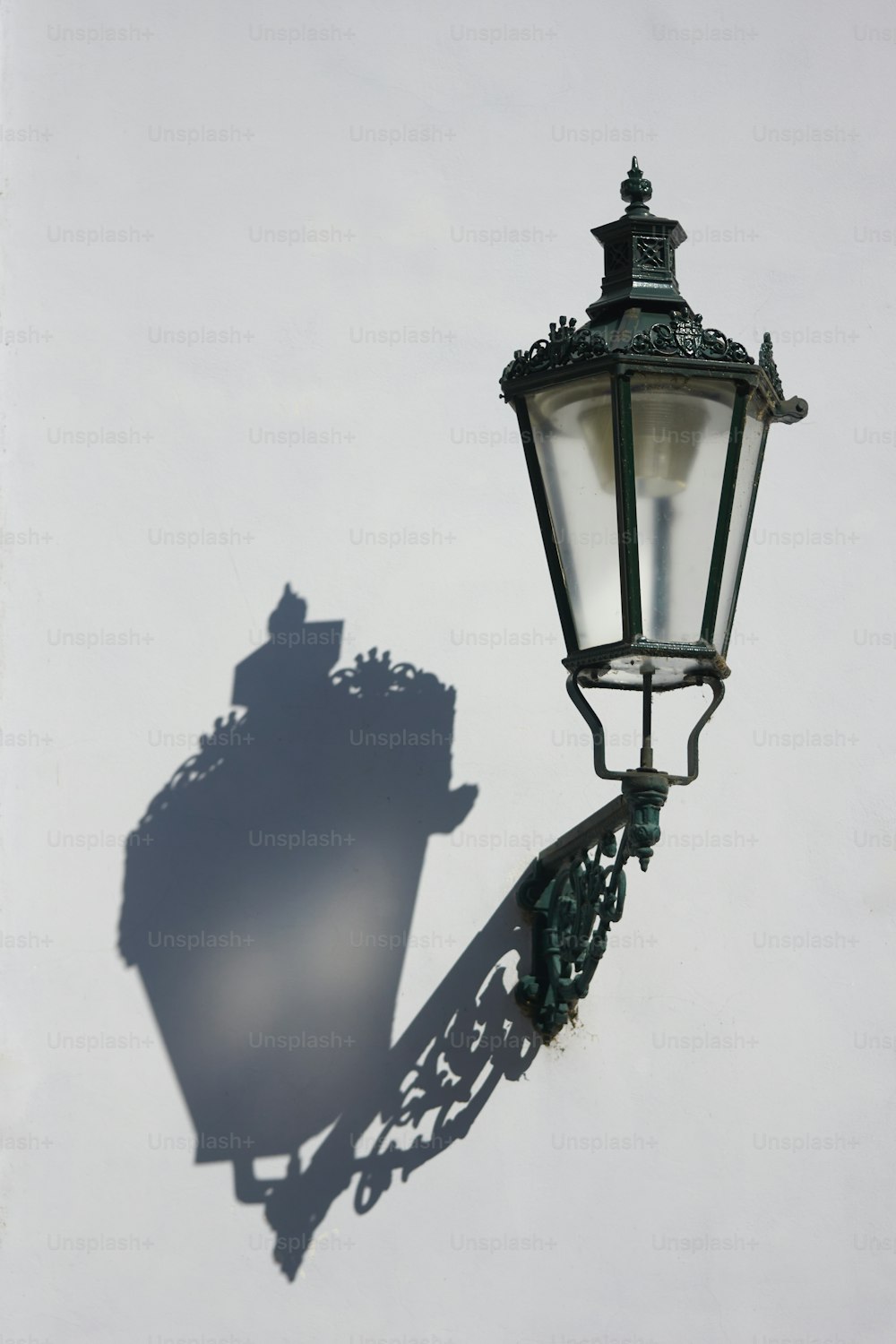 a street light casting a shadow on a wall