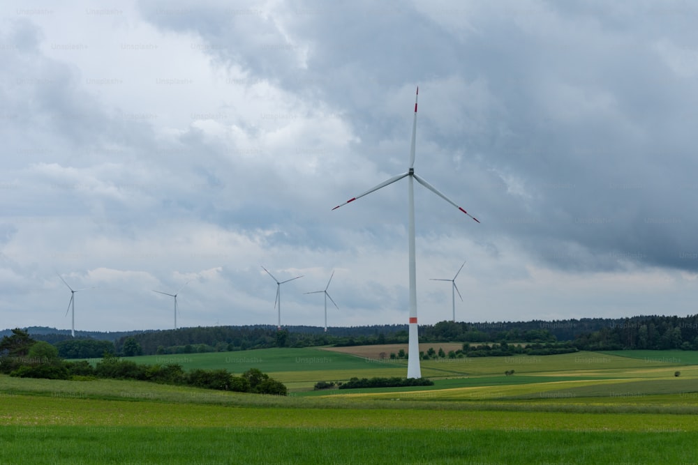 a wind farm with wind turbines in the distance