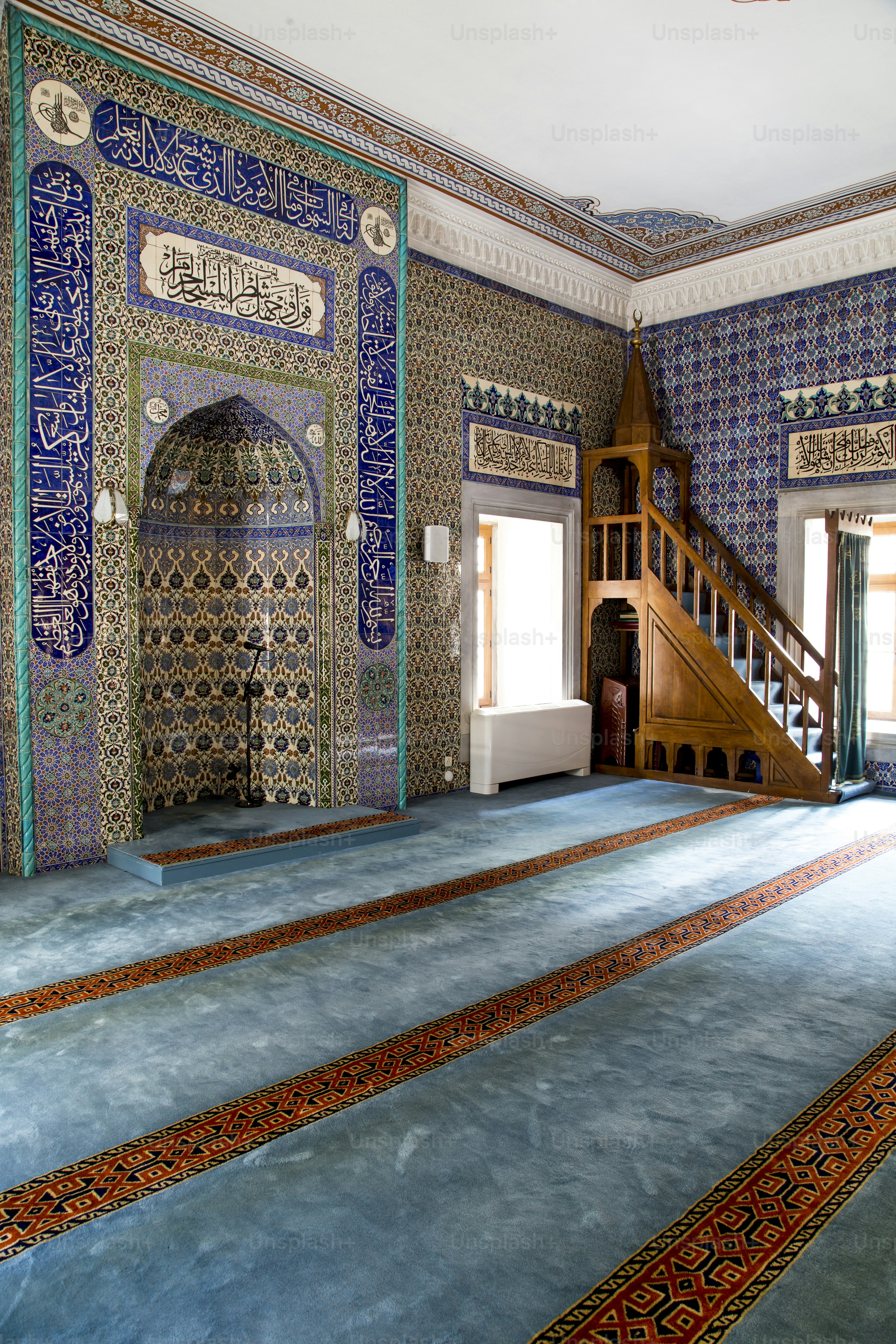 a room with a staircase and a carpeted floor