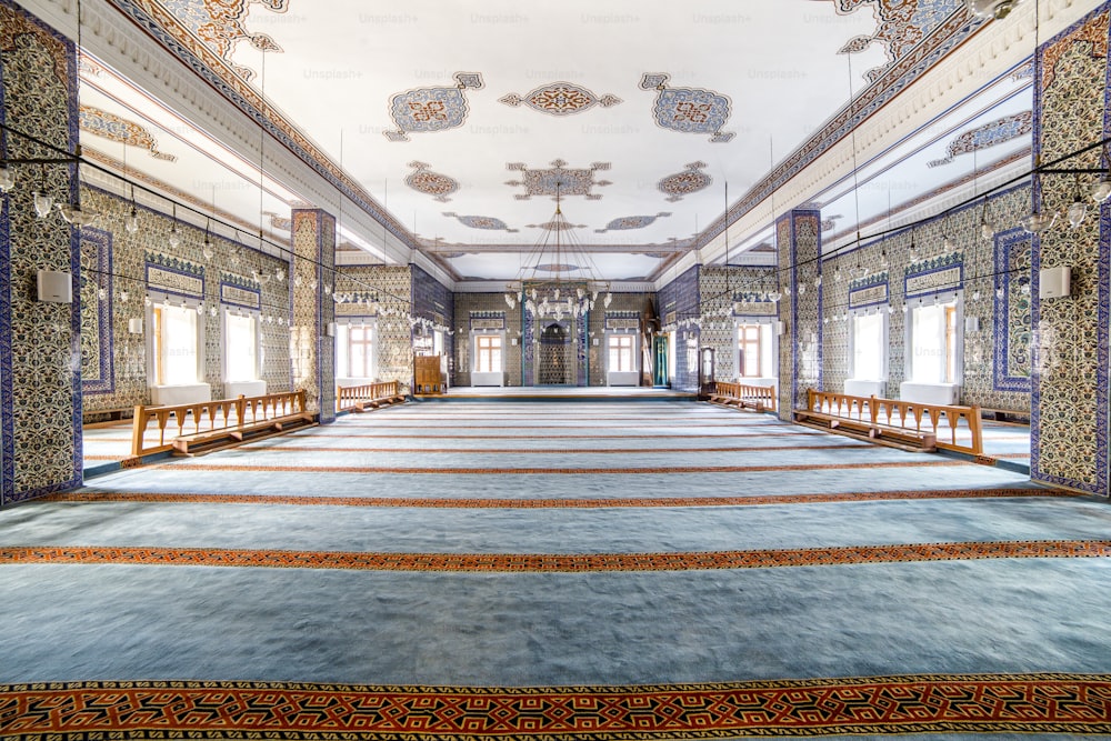 Una habitación grande con muchas ventanas y una alfombra en el suelo