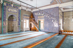 a room with a stair case and tiled walls