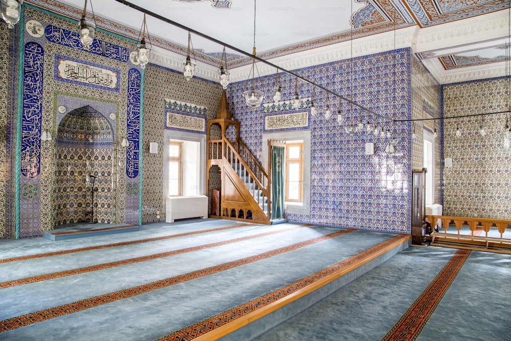 a room with a stair case and tiled walls