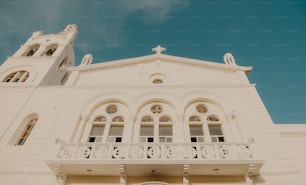 a large white building with a clock on the front of it