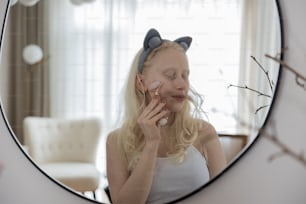 a woman is brushing her teeth in front of a mirror