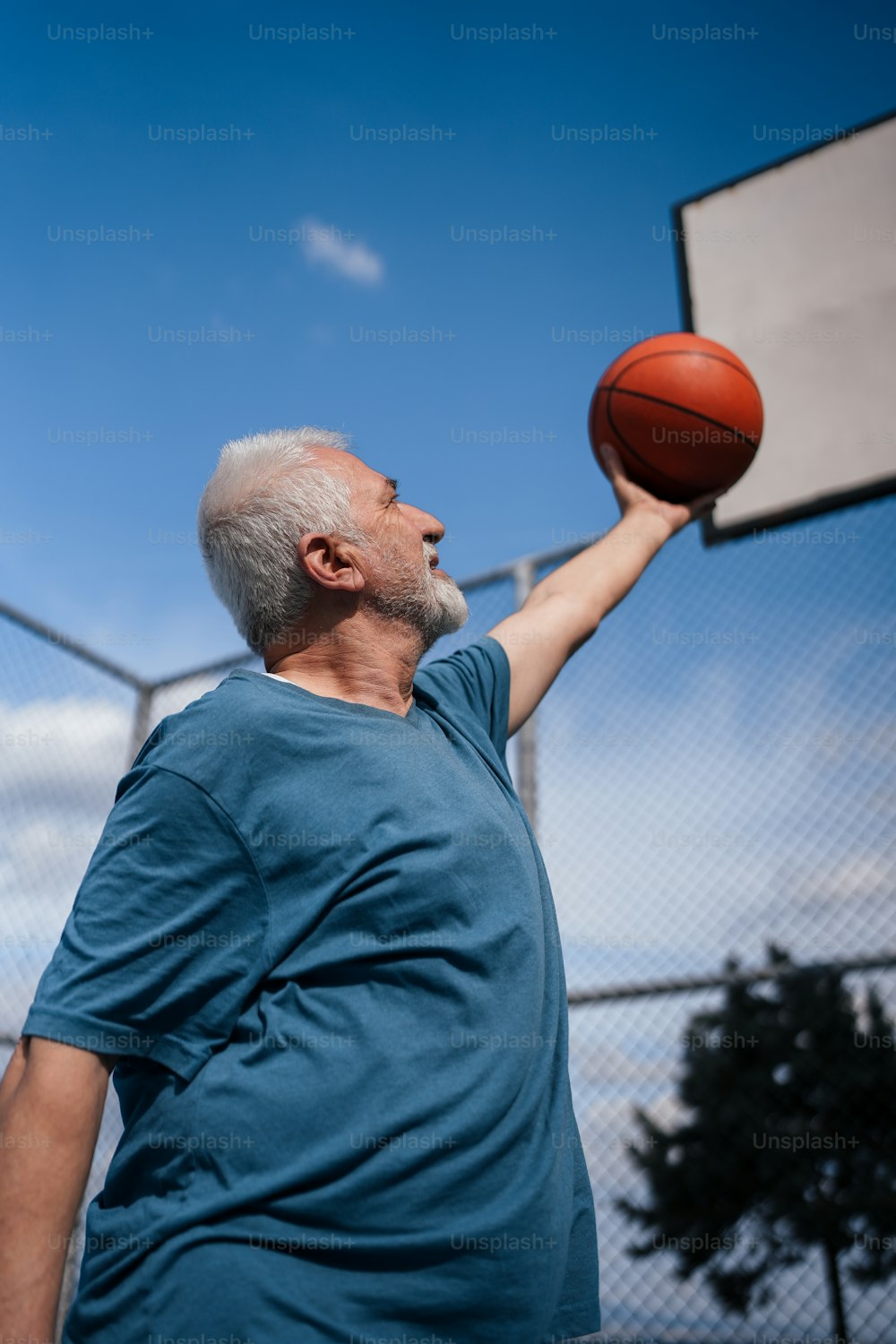 a man holding a basketball in his right hand