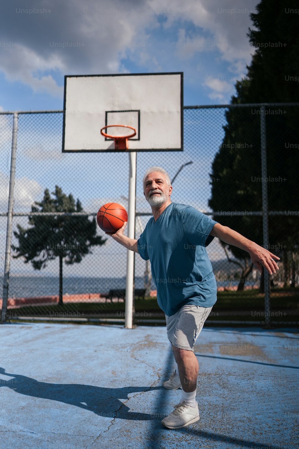 a man holding a basketball on a basketball court
