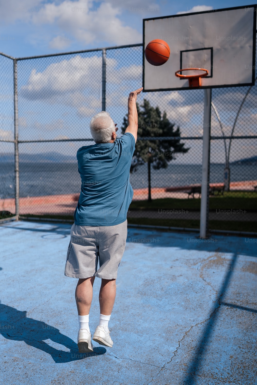 a man throwing a basketball into the air