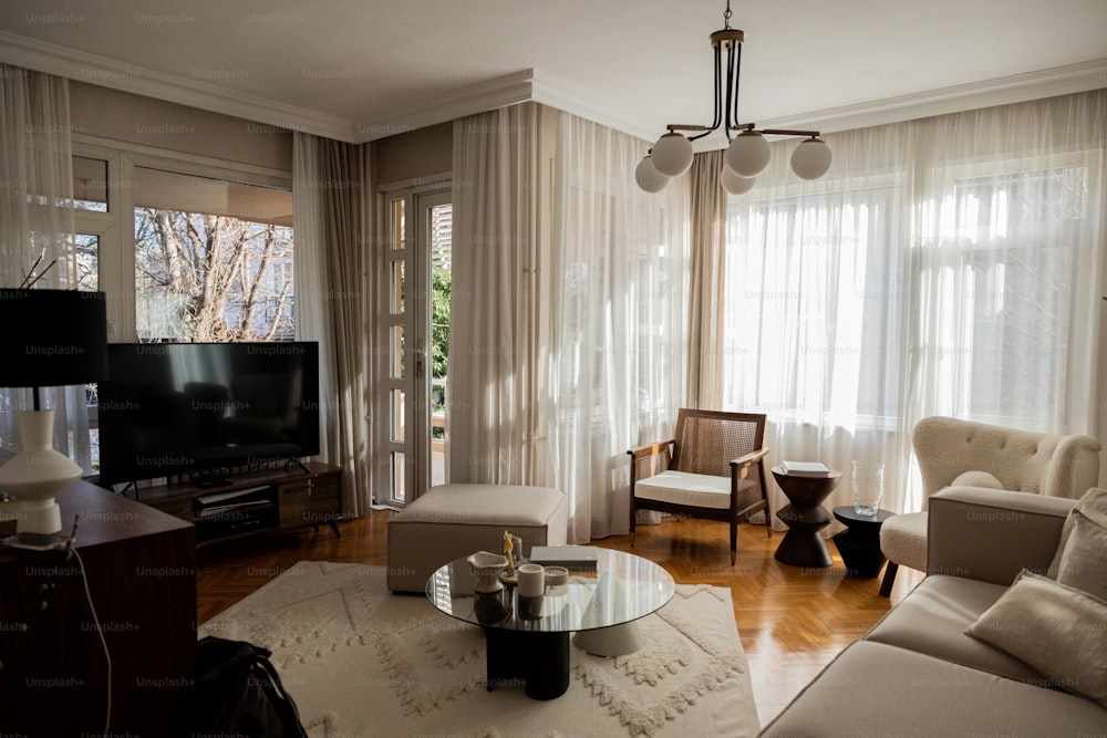 a living room filled with furniture and a flat screen tv