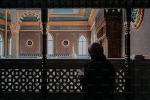 a woman looking out a window at a building