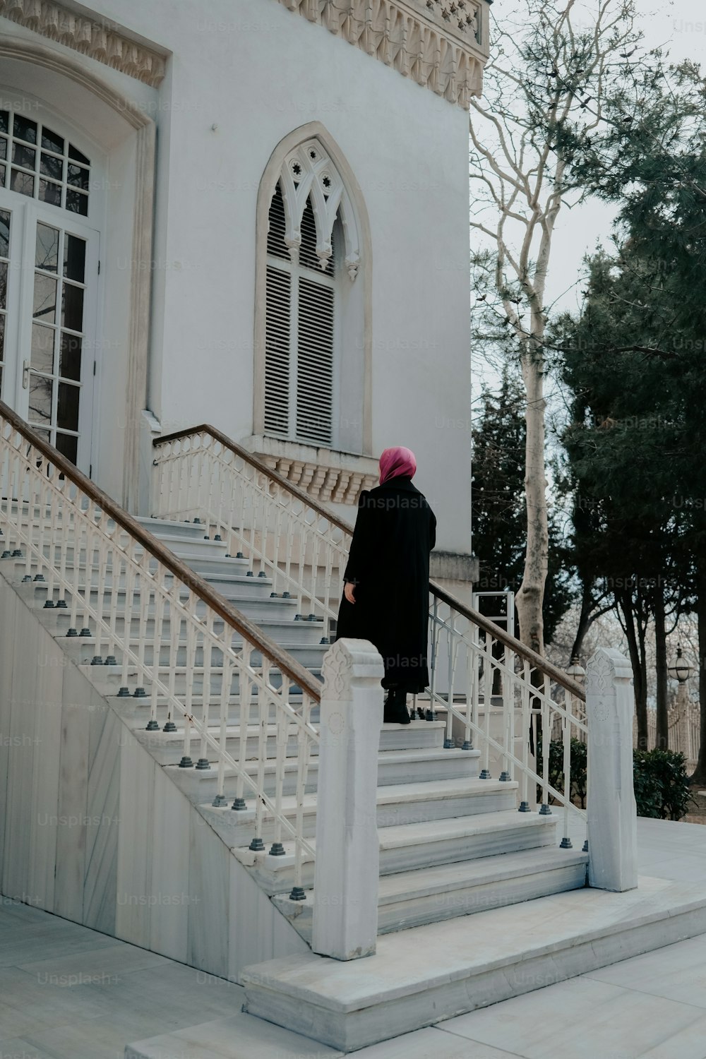 a woman walking down a set of stairs