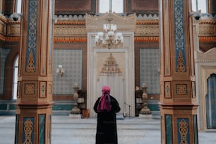 a woman in a black dress standing in front of a building