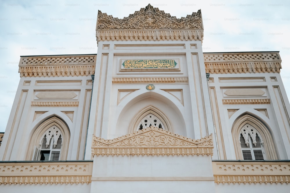 a large white building with a clock on it's side