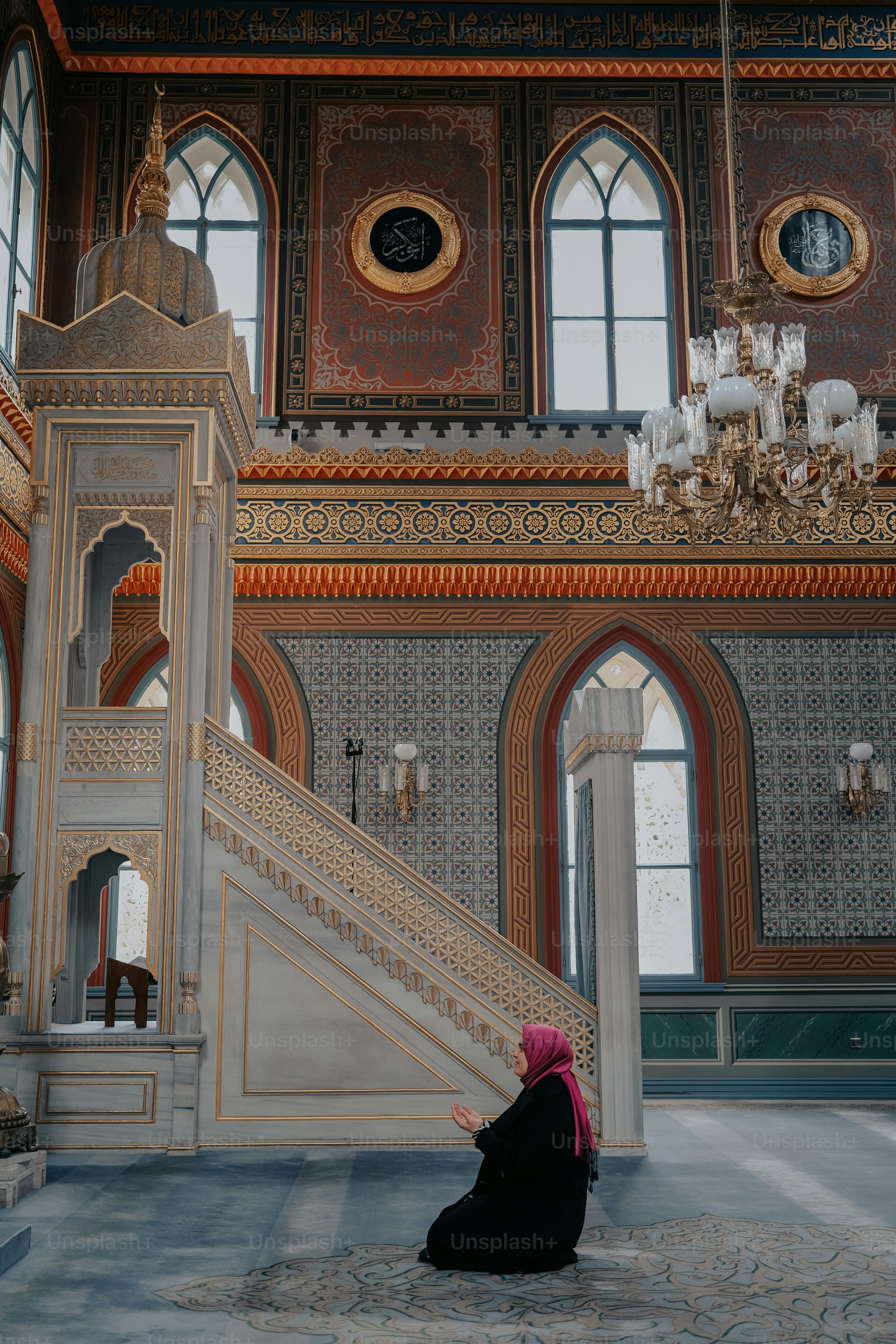 a woman sitting on the floor in front of a staircase