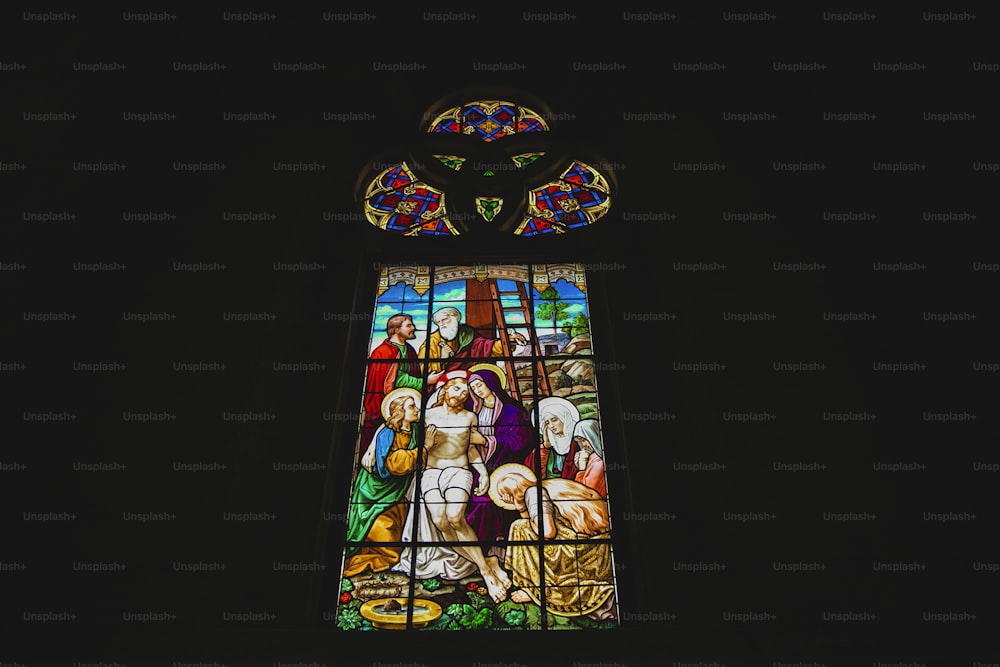 a stained glass window in a dark room