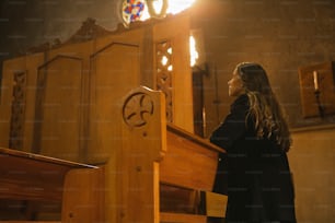 a woman standing at the alter of a church