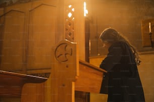 a woman standing at a pulpit in a church