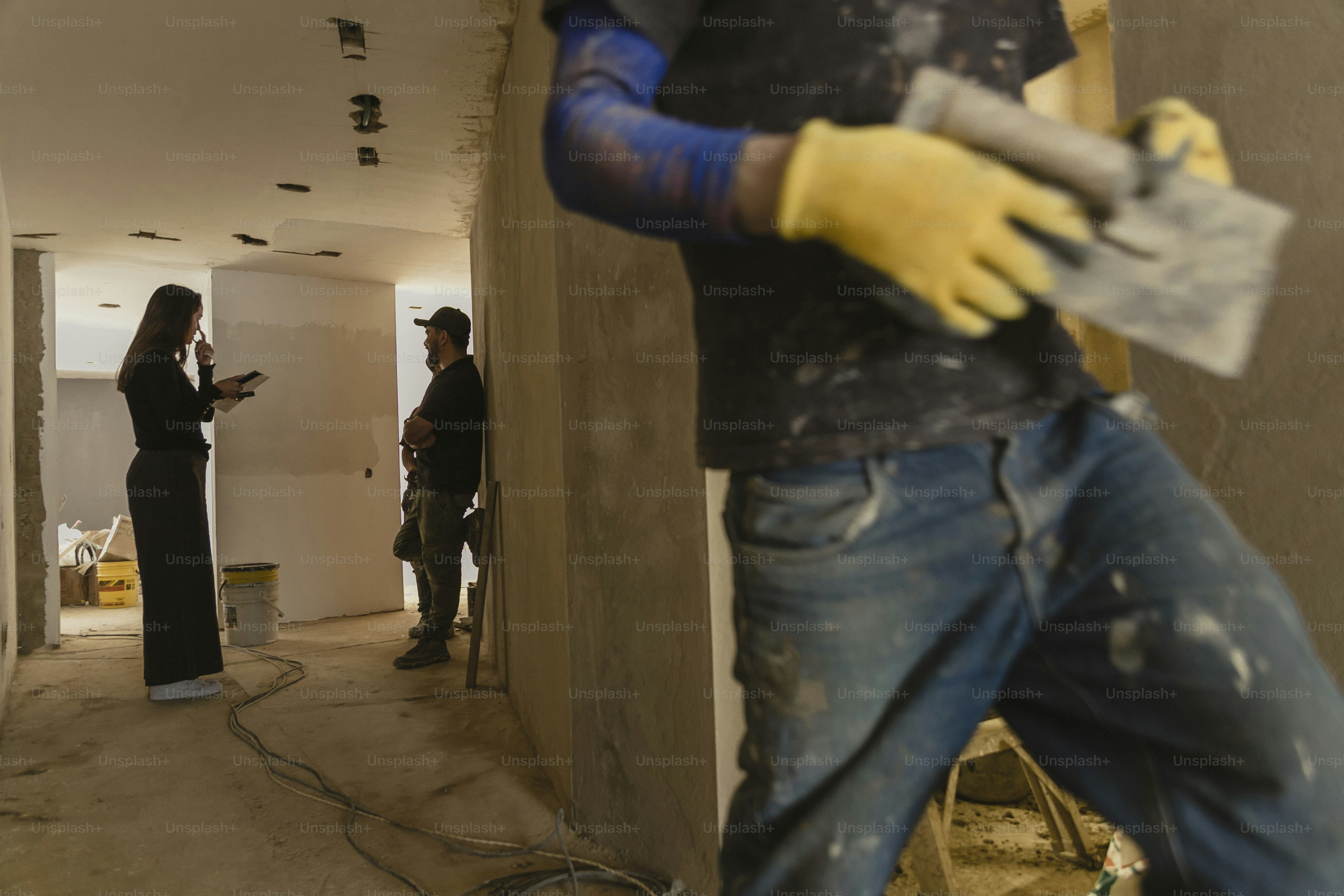 a group of people standing in a room under construction