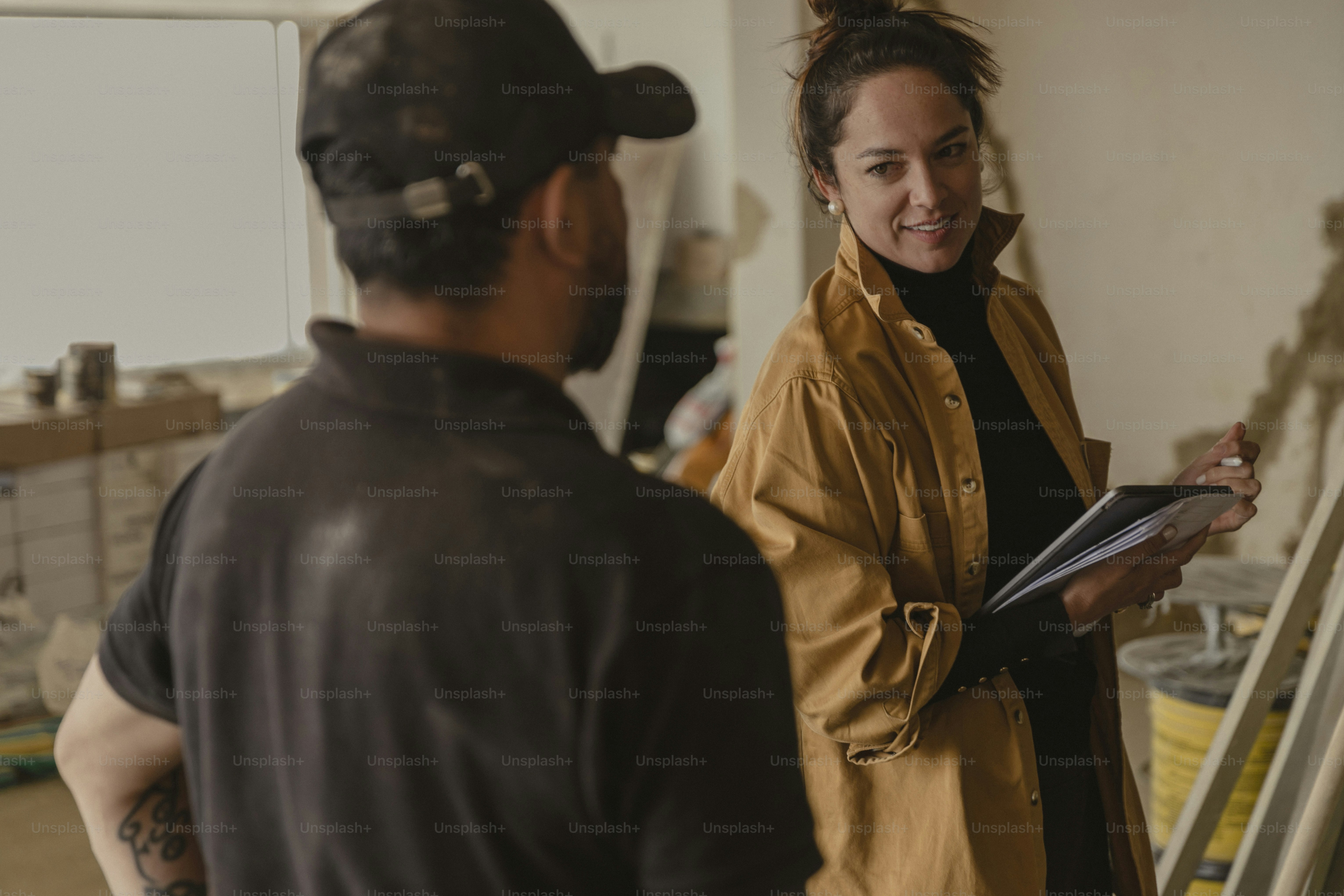 a woman standing next to a man holding a clipboard