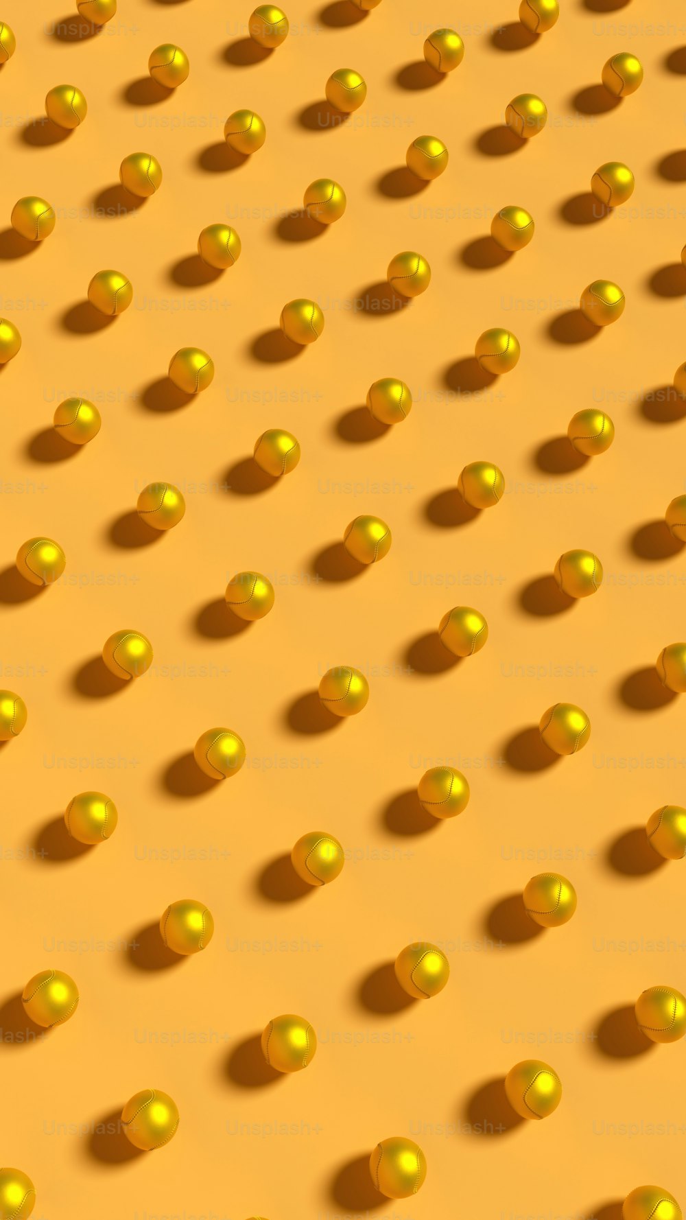 a group of yellow balls sitting on top of a yellow surface