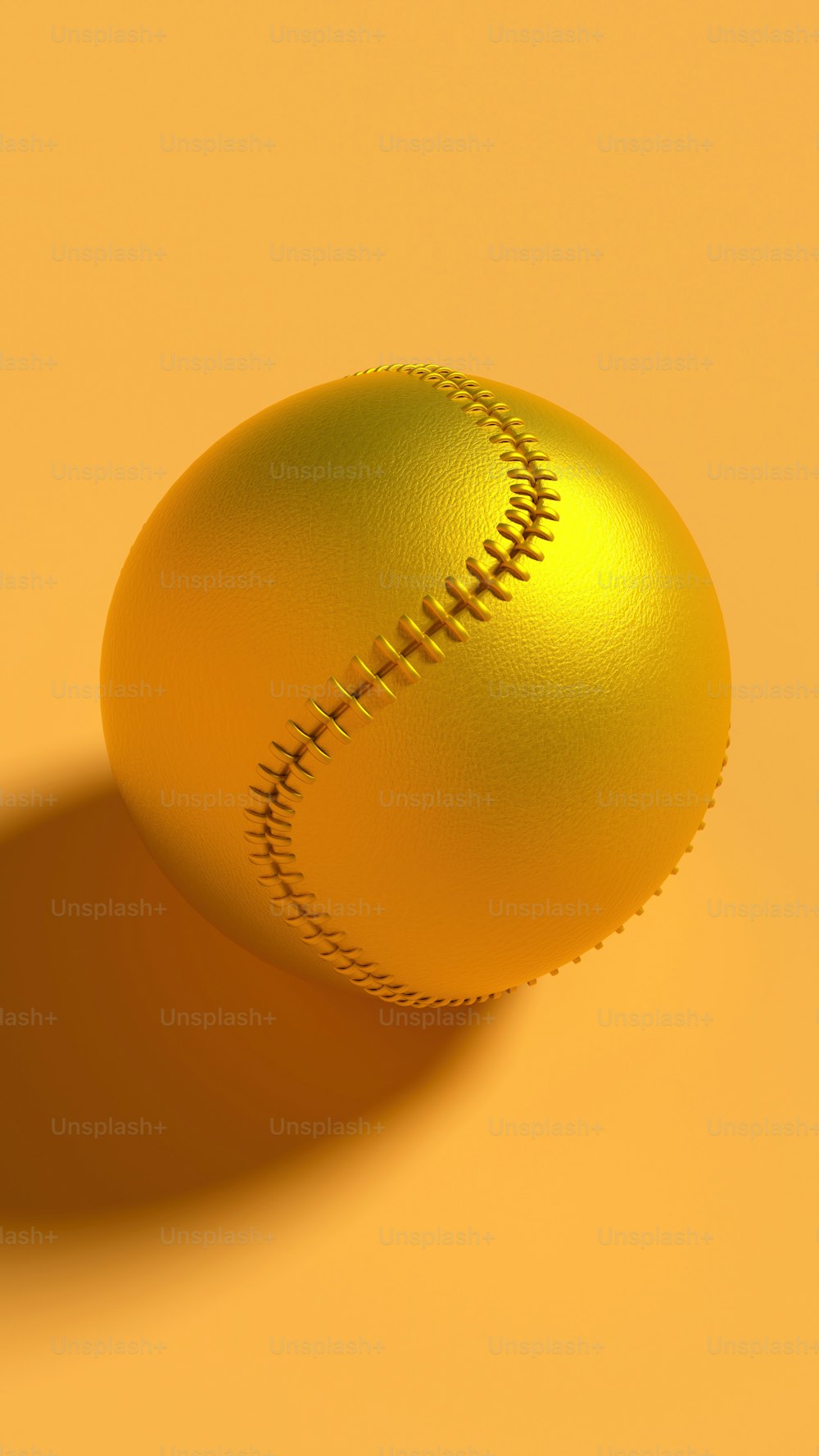 a golden baseball ball on a yellow background