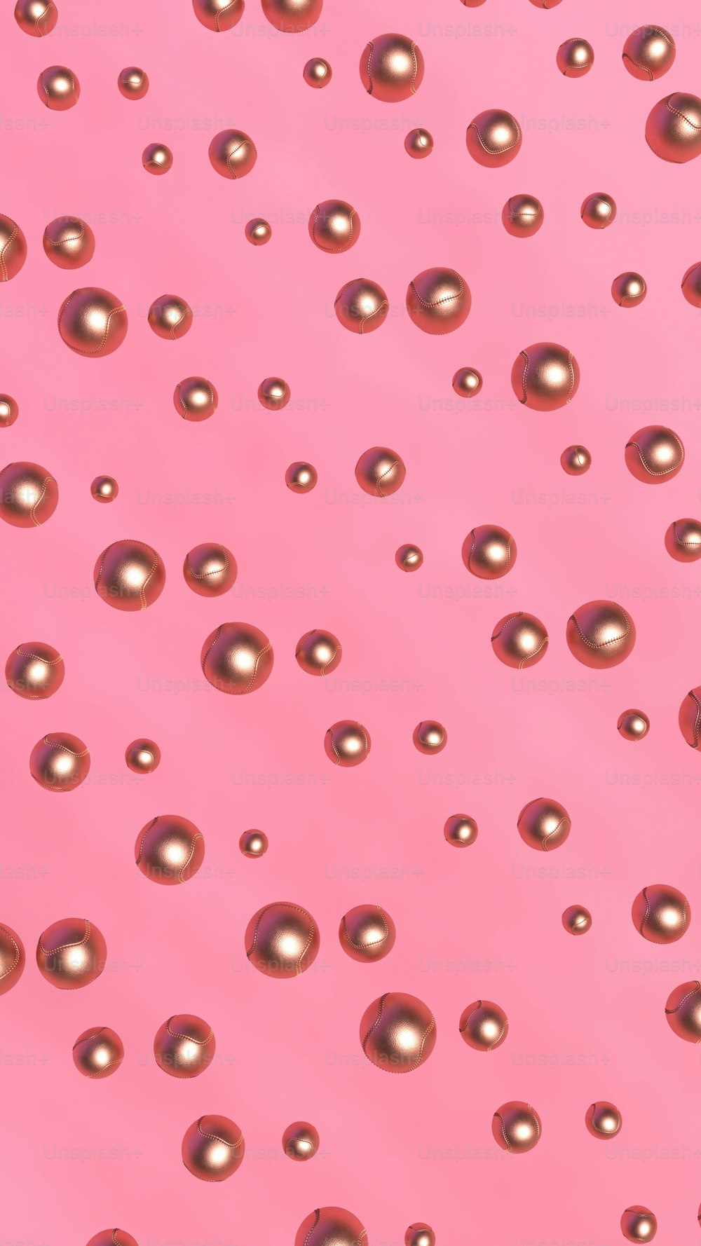 a pink background with lots of metallic balls