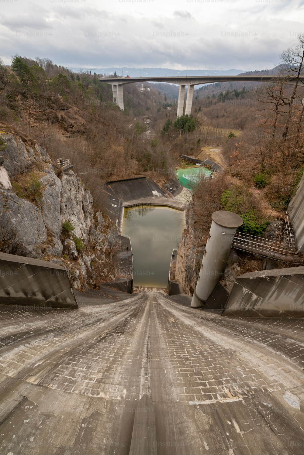 a road going through a tunnel with a bridge in the background