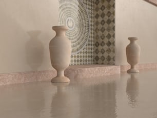 a couple of vases sitting on top of a counter