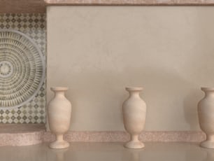 three white vases are lined up against a wall