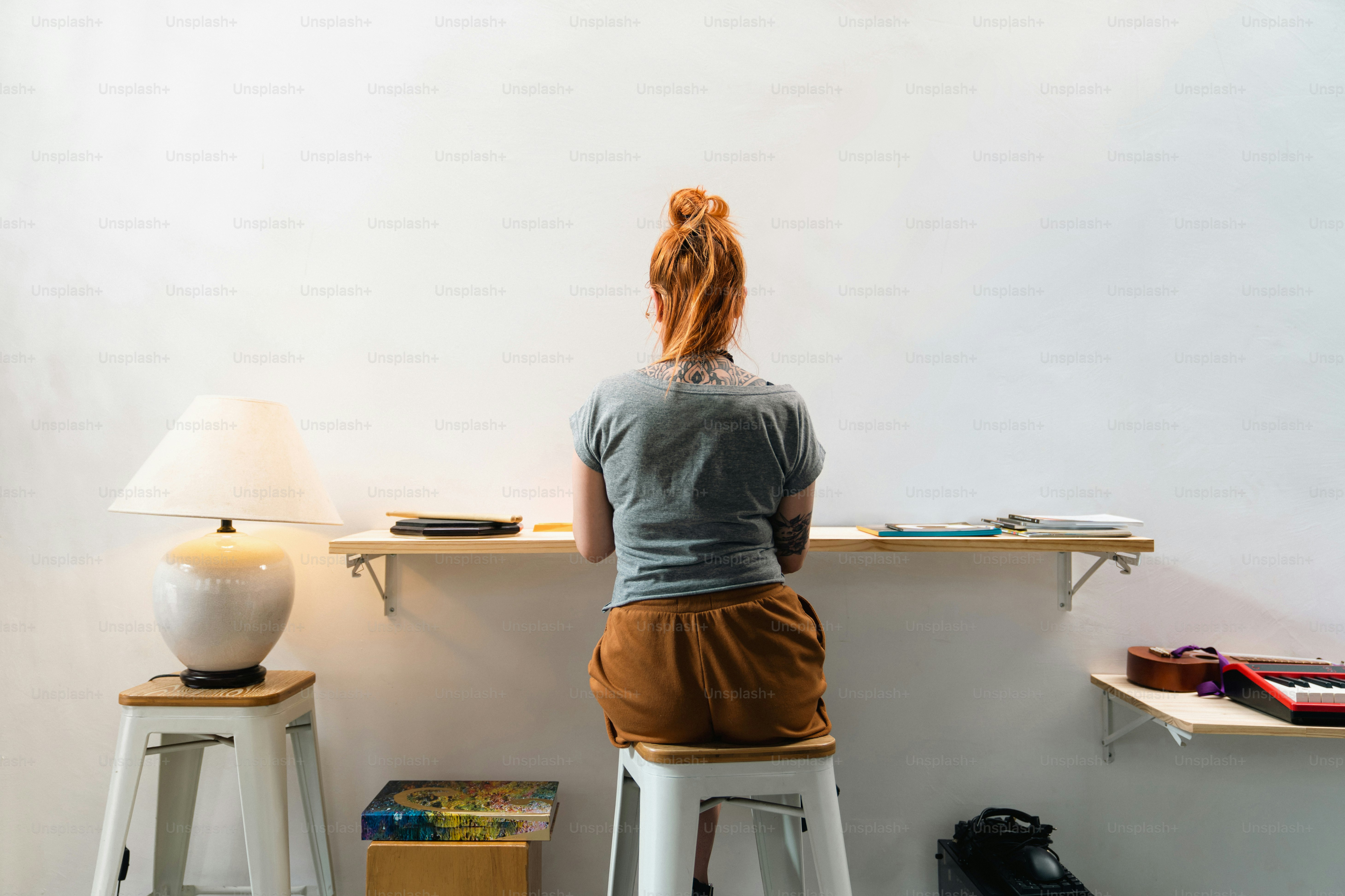 A woman sitting at a desk using a laptop computer photo – Coworking ...