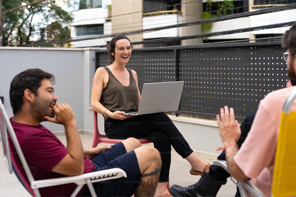 a woman sitting in a chair with a laptop