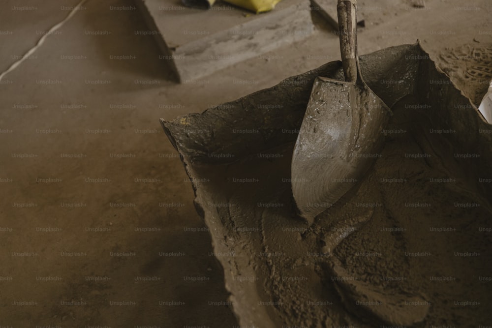 a shovel and some dirt in a room