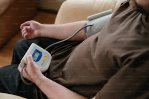 a man sitting on a couch holding a game controller