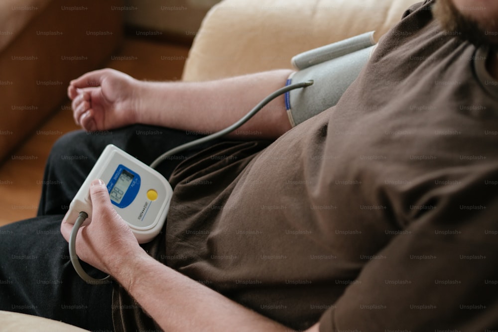 a man sitting on a couch holding a game controller