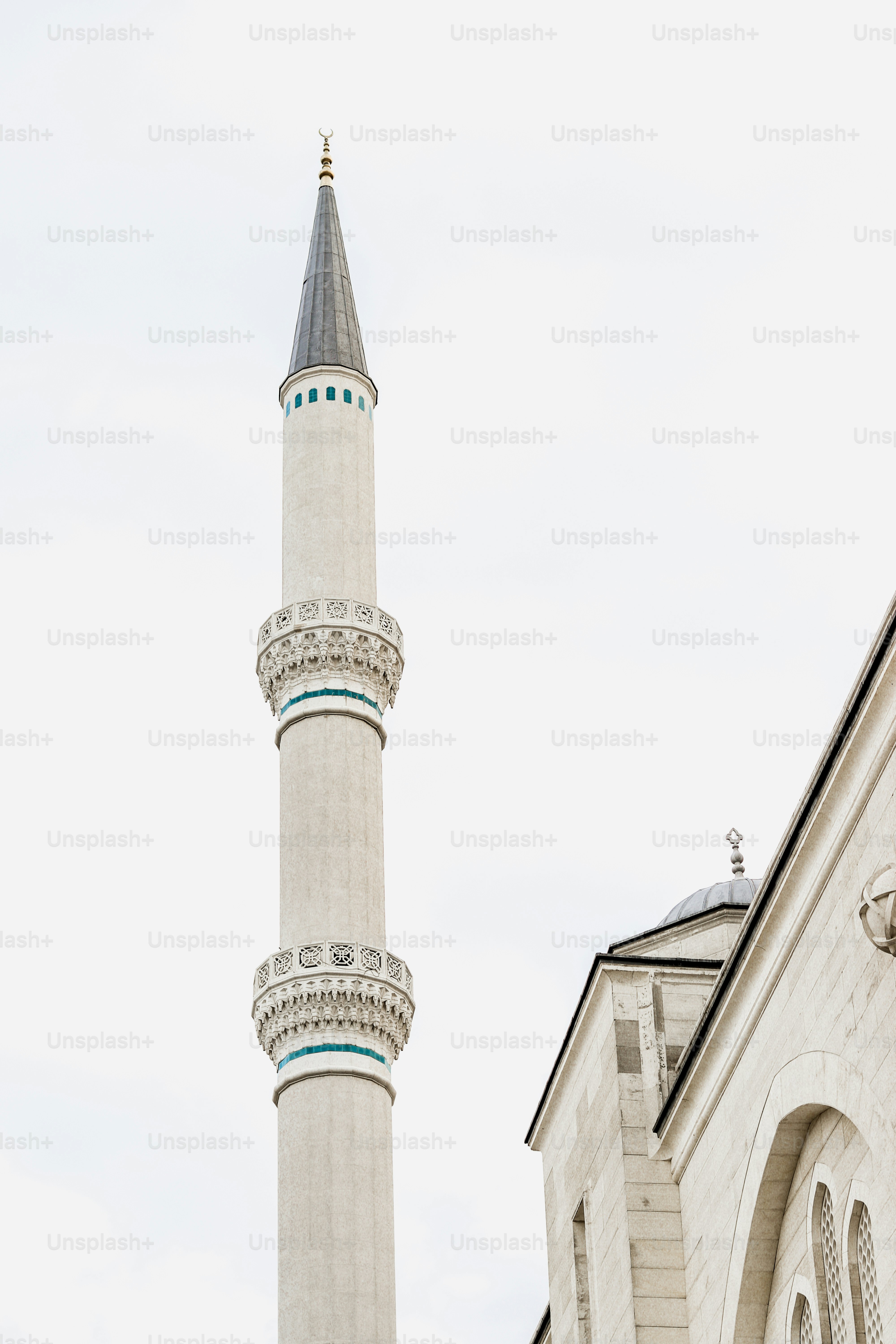 a tall white building with a clock on it's side