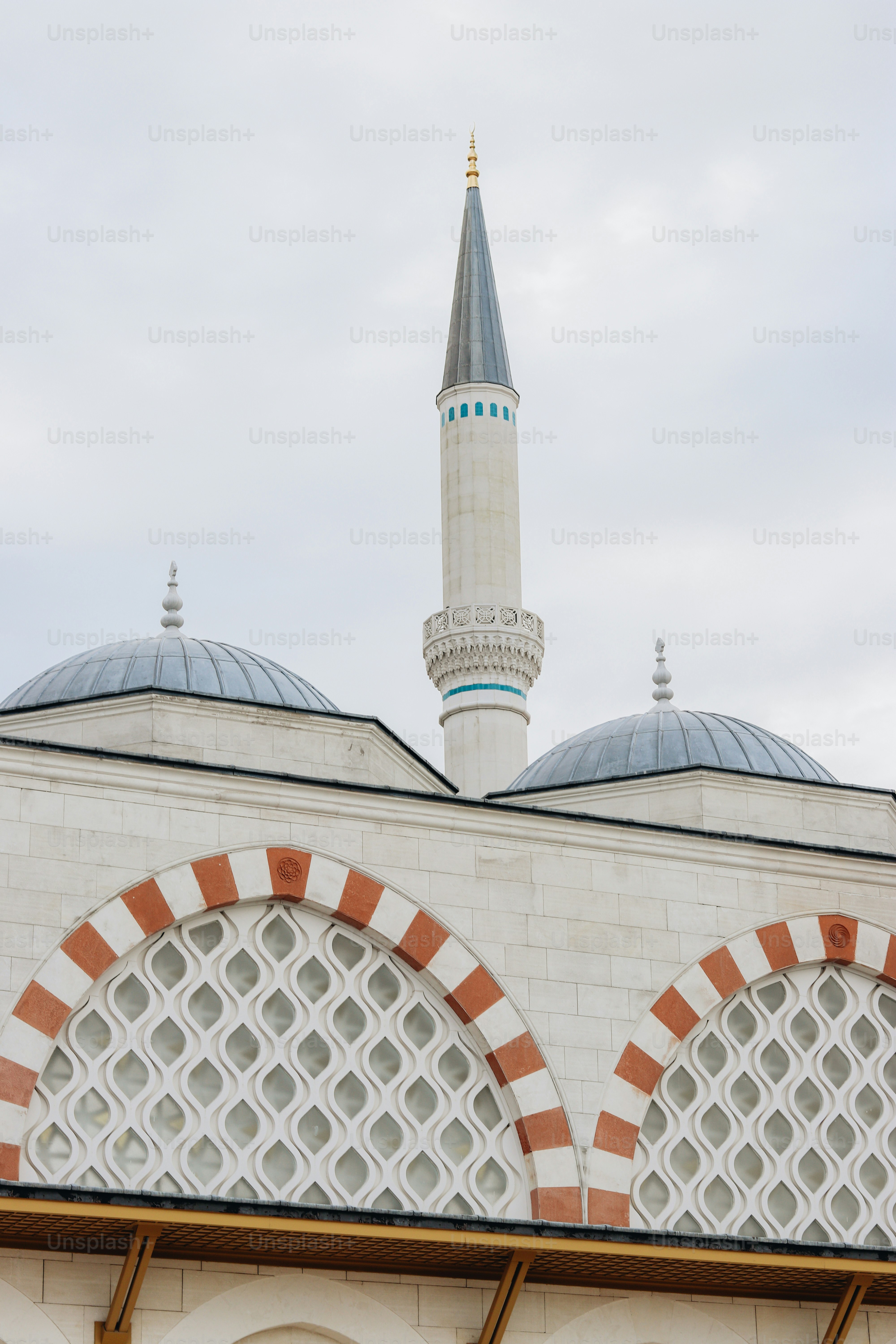 a tall white building with a blue and white dome