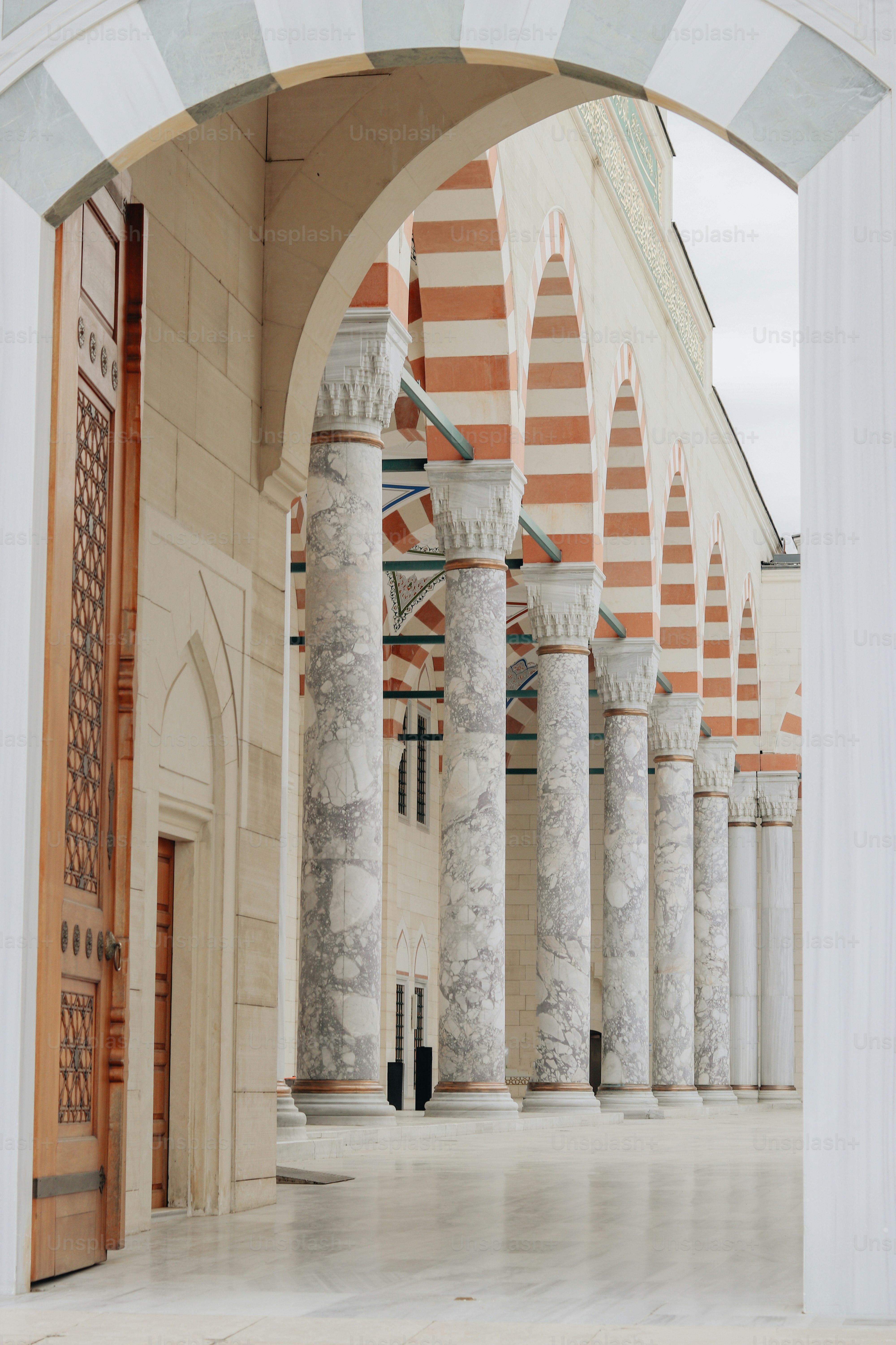 a building with columns and a clock on the front of it