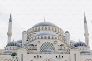 a large white building with two blue domes